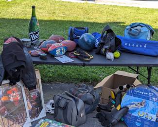 Some sporting goods, footballs, bowling balls, coats, MJ posters