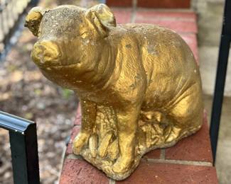 Vintage concrete pig with corn on the cob