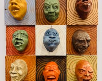 Set of 9 Olander Earthworks “Faces” hanging on a custom wood plaque 