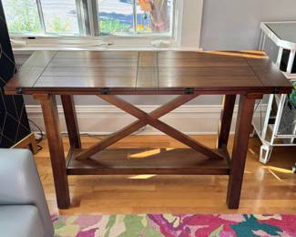 Space saving console that can fold open to a small dining table 