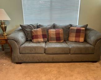 This is a moss green  colored suede sofa it also has a coordinating oversized chair