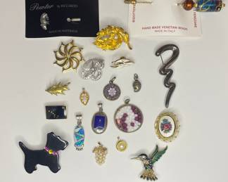 Vintage to modern collection of brooches, pendants, and hat pins  
Sterling silver, Monet, Venetian glass 