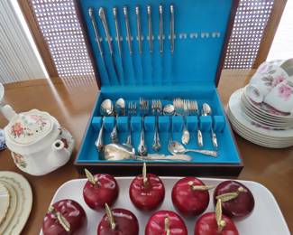 Silver plate flatware, apple ornaments, teapot and tea set.