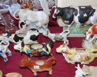 Collection of cows, Delft, Lladro, Germany, Japan, England, porcelain, bisque some are milk jugs some are ornaments.