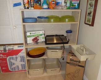 Bookcase, cleaning products, new in box ultra light hand held Shark vacuum. Box fans, Food Fresh vacuum sealing kit, plastic storage baskets.