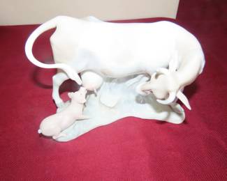 Lladro cow with pig feeding.