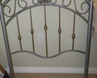 One of two matching brushed nickel twin headboards.
