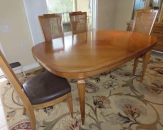 Dining table with 6 chairs, two extra leaves and table pads.