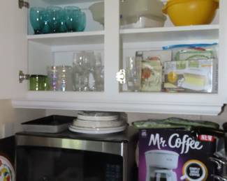 Microwave, new in box coffee maker, stemware and kitchen utensils.
