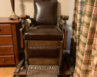 Antique Hydraulic Barber Chair in great condition shown sitting on a dolly for an easy move