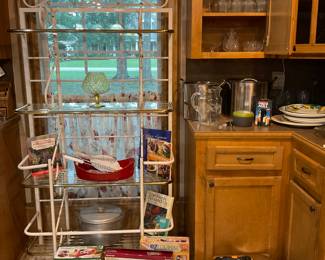 Large white and gold bakers rack covered in kitchen items