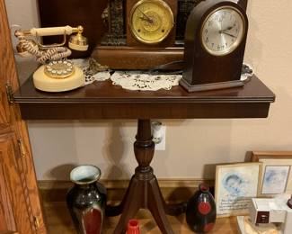Gorgeous card table with antique clocks, phone and assorted pieces