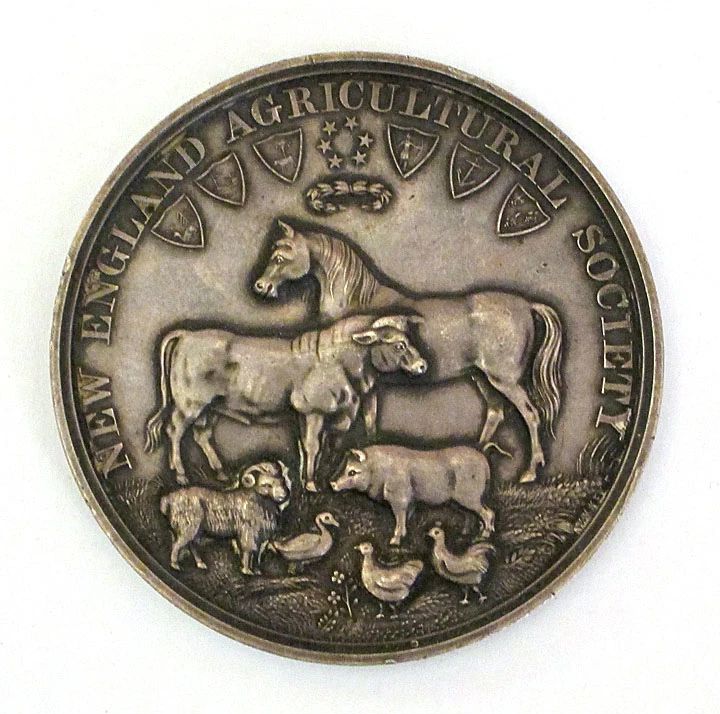 Silver medal awarded by the New England Agricultural Society to Wallace P. Mack, 1884