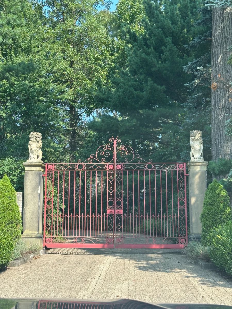 Early 20th century pair of  wrought iron entranceway gates  (including two pedestrian  gates) with central crest and Tudor rose decoration in all corners . (Lions sold separately.) 