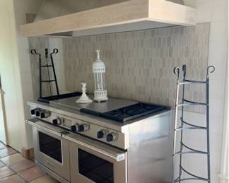 Stove in kitchen with Astier de Villatte pieces. 