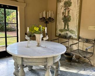 Close up of the marble-top table with a blue tint white washed wooden base.