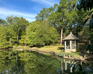 Another view of one of the ponds in property with "Geese Landing", bronze, by David Norris (20th century) in the distance. 