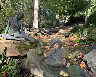 View of 'Seated Girl with Ponytail fixing her Sandal' by Carl Mellis (20th century).  Bronze with verdigris patina.
 
‘Group of Geese’ by Lloyd Le Blanc (b.1940) Bronze with verdigris patina. 22”H and smaller. 
