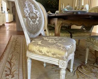 A set of nine Louis XVI style cream-painted dining chairs (7 side chairs; 2 arm chairs)