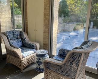 Pair of rattan chairs with porcelain garden stool.