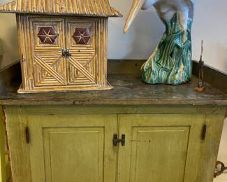 Painted cabinet, porcelain egret statue