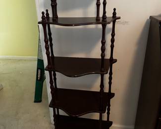 A sturdy and very precious small knickknack shelving unit