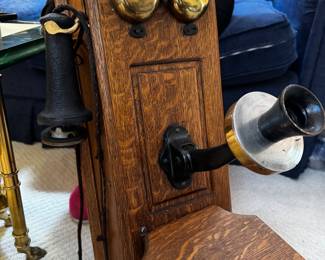 Antique wall phone in tiger oak case