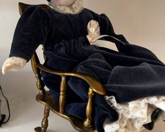 Old doll in rocking chair