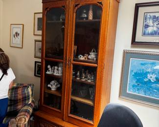 Victorian era bookcase, double doors, glass front, drawer below, and elaborate, carved pediment