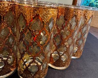 A very large set of bar wear with 10 tall glasses and eight smaller plus an ice bucket and tongs