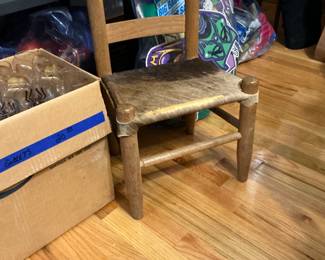 The little chair from the 30s is covered with deer skin