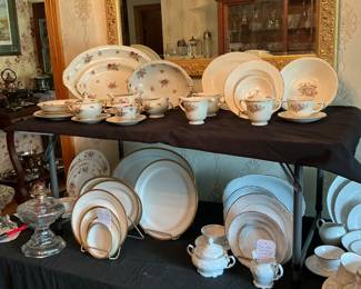Numerous China sets a one place setting is set out for each pattern