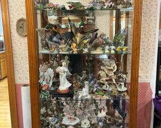 Sliding glass door curio cabinet full of Andrea Lefton pieces