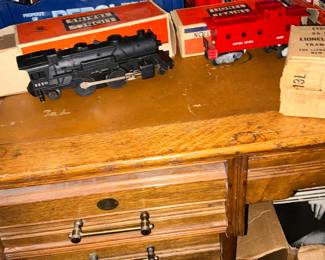 The engine and cars still in original box with wrapping around the wheels