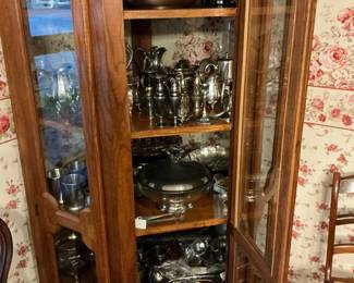 Curio cabinets full of silver plate, serving pieces
