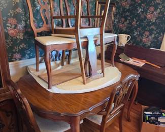 #2	Wood Dining Table w/1 leaf & 5 matching chairs ( 6th Chair Slightly Different) 1 chair as is stain on Seat - 60-72x40x31	 $225.00 
