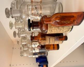 Antique apothecary glass bottles, amber and clear medicine jars, vintage pharmacist decor