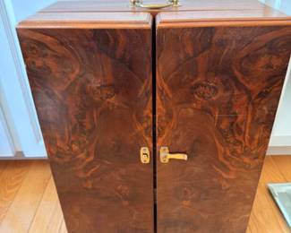 Mid-century burl wood liquor or apothecary case featuring beautiful wood grain, brass handle and lockable doors; stylish decorative storage box.