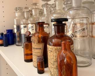 Antique apothecary glass bottles, amber and clear medicine jars, vintage pharmacist decor