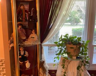 Brass/glass stand, dolls, curtains, live plant