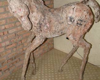 The image displays a sculpture of a young horse, likely a foal, created by artist Siri Hollander