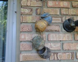 Pottery jugs on a rope, hanging on the wall