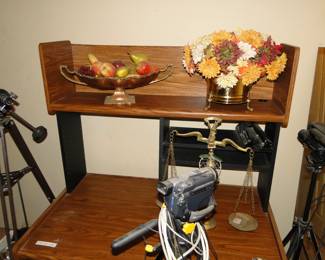 Brass items with faux fruit, and faux flowers too, and more camera equipment too