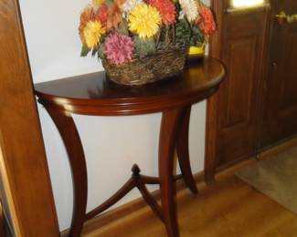 1/2 round table, plays nicely with the wall, in a complete fit of fashion