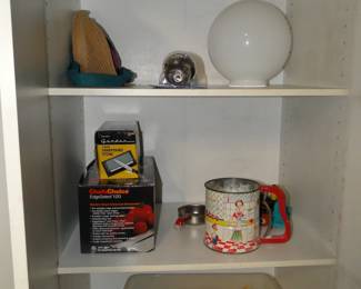 Electric holiday candles on the bottom shelf and some other household items too