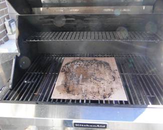 Besides the mat on the inside the grill is as clean as clean can be