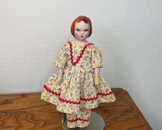 Vintage porcelain doll on stand
