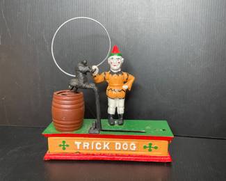 Vintage cast-iron mechanical coin bank known as the "Trick Dog