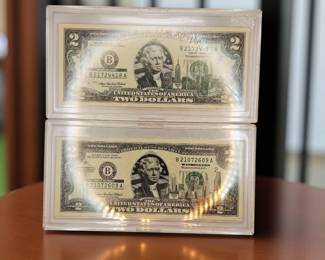 United States of America commemorative $2 bills in original uncirculation sleeves . We have multiple obese 