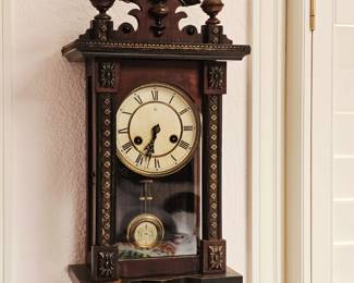 Antique wind up wall clock in working condition but unknown if it keeps accurate time. Key included 